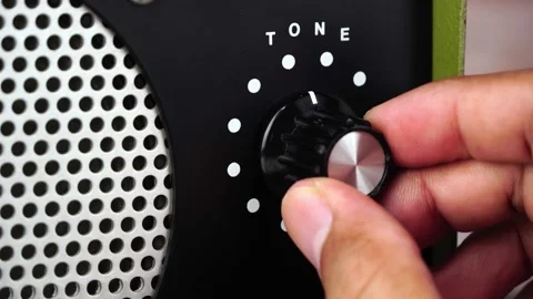 Hand adjusting volume tone control. Use hand to adjust the volume tone Stock Footage 169243427
