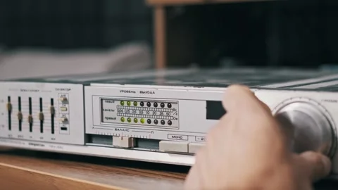 Hand Adjusting Volume on Vintage Audio Amplifier Stock Footage 318164044
