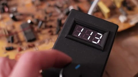 Hand Adjusts Control Knob Increasing Digital Voltage Meter Value Stock Footage 306045121