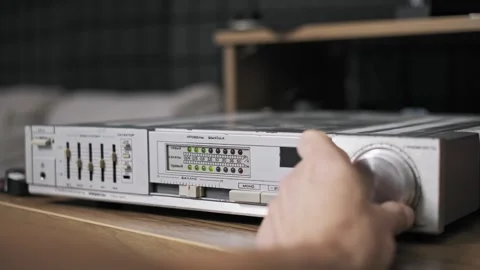 Hand Adjusts Old Amplifier Volume Knob Wide Shot Stock Footage 318788544