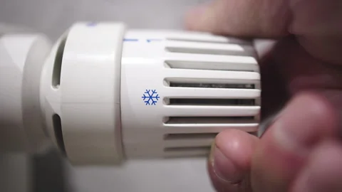 A hand adjusts the radiator temperature Stock Footage 322819907