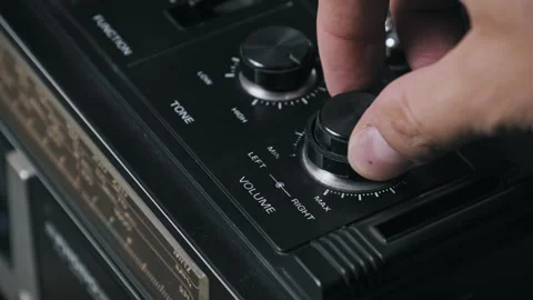 Hand Adjusts Volume Knob on Retro Radio Cassette Deck Stock Footage 319068622