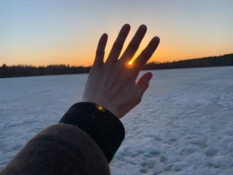 Hand against the sun Stock Photos