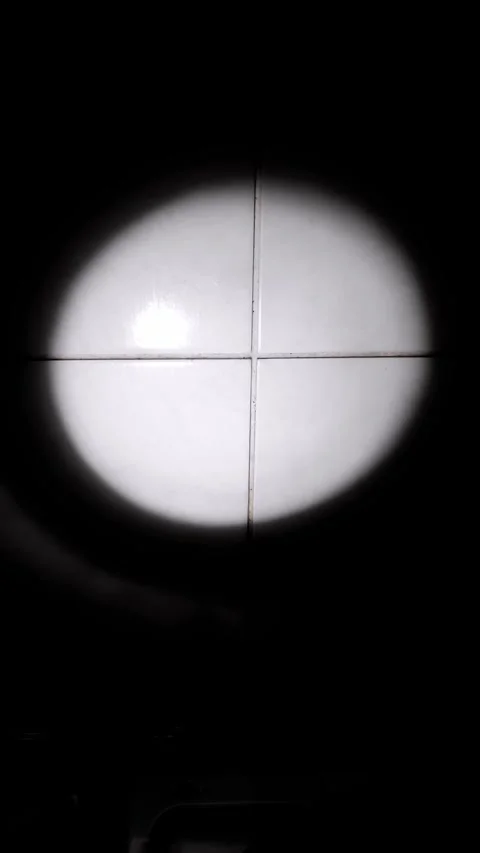 Hand Aims Flashlight Beam on Tiled Surface in Darkness Stock Footage 325223992