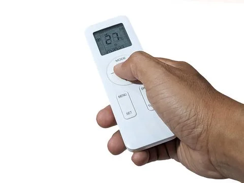 Hand with air conditioner remote control Stock Photos