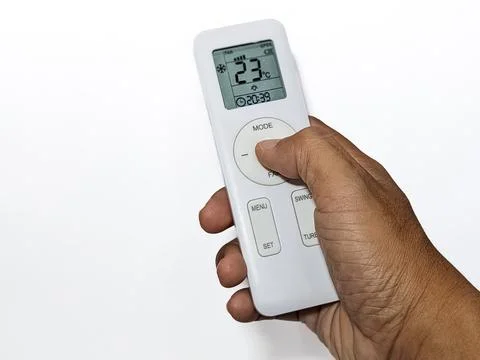 Hand with air conditioner remote control Stock Photos