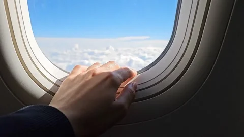 Hand on an Airplane Window During Flight Stock Footage 314805441