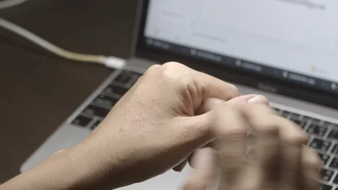 Hand and arm itching cause eczema while working with laptop Stock Footage