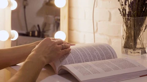 Hand and book: reading a book and holding your fingers along the lines. A woman Stock-Footage 101289866