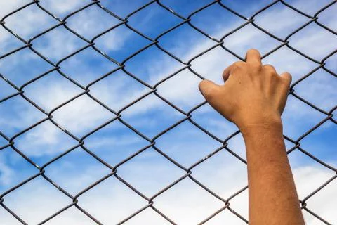 Hand and cage Stock Photos