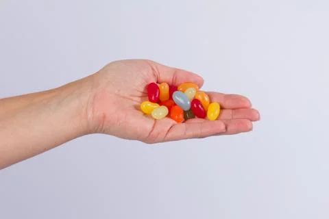 Hand and candy Stock Photos