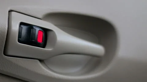 Hand and central lock handle color red to lock the car door interior Stock Footage 65297411