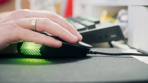 Hand and computer mouse with multicolored lights. Close-up Stock Footage 68944770