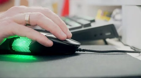Hand and computer mouse with multicolored lights. Close-up Stock Footage 68944816