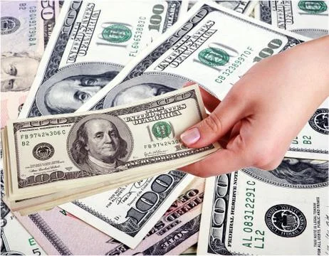 Hand and dollars Stock Photos