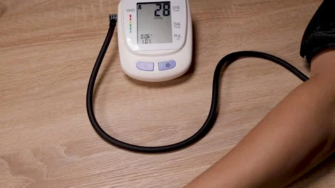 Hand and electric tonometer on table for measuring blood pressure Stock Footage 224145467