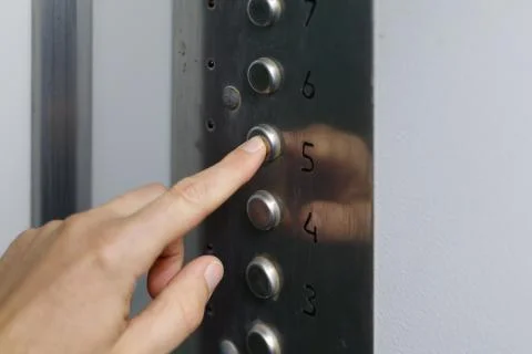 Hand and finger press the elevator button Foto stock