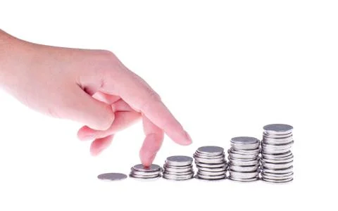 Hand and growing stack of coins Stock Photos