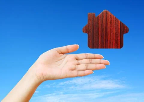 Hand and icon house Stock Photos