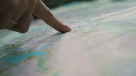 Hand and map1 Stock Footage 129807700