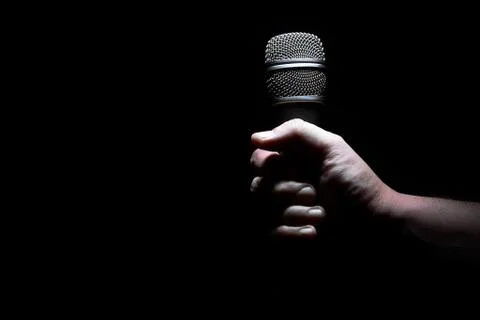 Hand and microphone Stock Photos