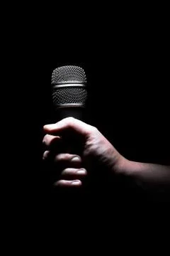 Hand and microphone Stock Photos
