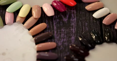 Hand and nail design samples. Selection of colour shellac nail polish. Stock Footage 149897109