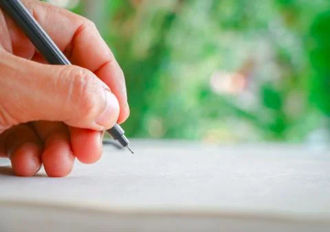 Hand and pen Stock Photos