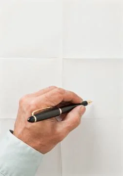Hand and pen write over sheet of paper Stock Photos
