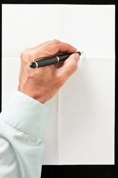 Hand and pen write over sheet of paper Stock Photos
