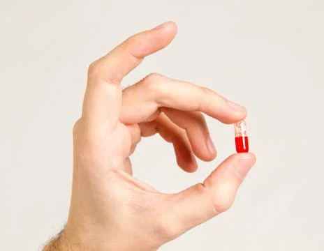 Hand and pill Stock Photos