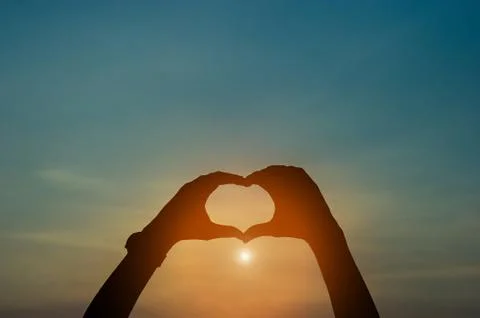 Hand and shadow in the corner. sunset And there is show of love.  silhouette  Foto stock