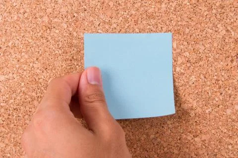 Hand and sticky post it note Stock Photos