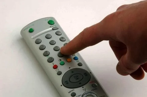 Hand and tv remote control Stock Photos