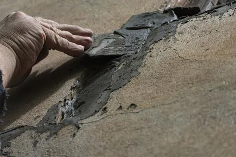 Hand Applying Cement with Trowel on Wall Stock Photos
