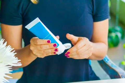 Hand applying cream Stock Photos