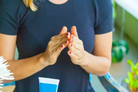 Hand applying cream Stock Photos