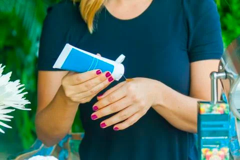 Hand applying cream Stock Photos