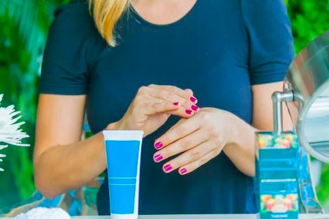 Hand applying cream Stock Photos