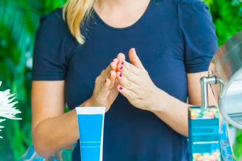 Hand applying cream Stock Photos