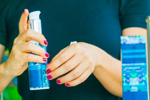 Hand applying cream Stock Photos