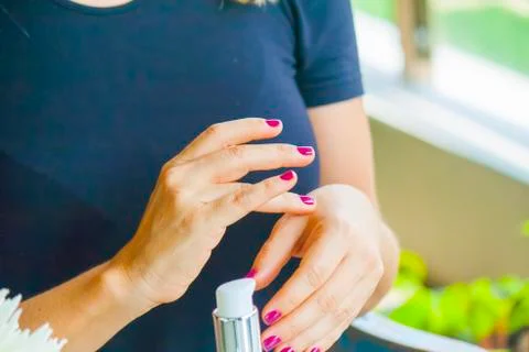 Hand applying cream Stock Photos
