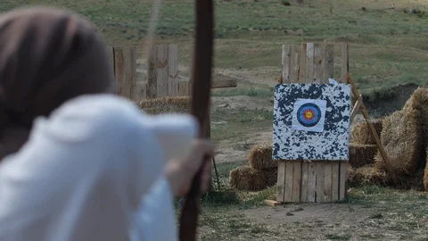 Hand of the archer pulls the bowstrings on the bow slow motion footage Stock Footage 100179904