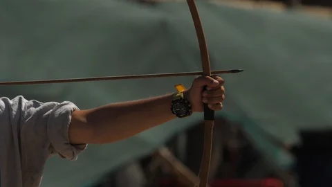 Hand of the archer pulls the bowstrings on the bow slow motion footage 스톡 동영상 100180522
