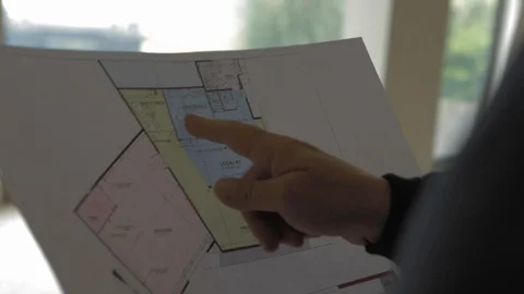 Hand of architect man looking at house building blueprint. Businessman at Vídeos de archivo 110772092