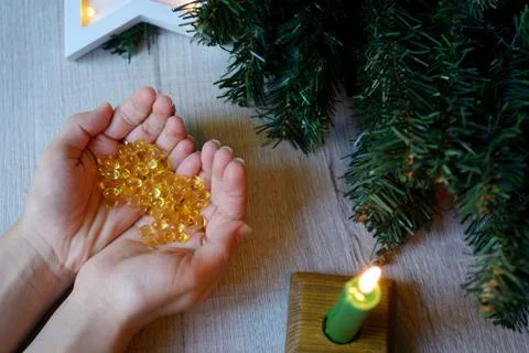 In hand are vitamins D for immunity and Christmas decorations, Stock Photos