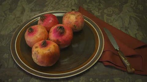 Hand arranges pomegranates on serving platter. Stock Footage 41860280