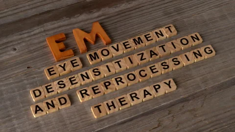 A hand arranging the abbreviation EMDR. Its explanation is visible. Stock Footage 332850543