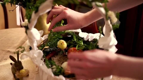 Hand arranging easter basket brought to church to be blessed on Holy Saturday Stock Footage 103810318