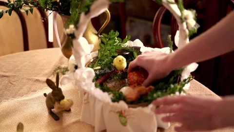 Hand arranging easter basket brought to church to be blessed on Holy Saturday Stock Footage 103848146